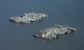 flying2005-23 Decommissioned Navy ships berthed in the Sacramento River. There's a aircraft carrier at the end of the bottom row.