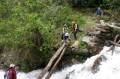 img_8041-ray This crossing was pretty harrowing. The waterfall drops off just a few meters downstream. The bottom two logs were wet and very slick and you couldn't rest any weight on it. The top log was dry but it was shaky and we had to lean our weight on the top log while sliding across on the bottom. I initially wanted to straddle the log and move across but I quickly realised that it was a bad idea because of the large and heavy pack I was carrying. Taken by Ray Woo.