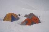 shasta33 Our tents covered by fresh snow the next morning. The conditions were still pretty bad with winds gusting at around 30 miles per hour and snow still falling.