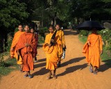 crw_7267 Buddhist monks walking towards Bakong at sunset.