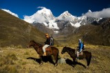 _mg_1651 Ray and Serene on their horses with Yerupaja (6617 m), Yerupaja Chico (6089 m), and Jirishanca (6094 m) in the background.
