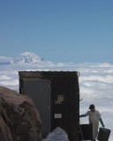 crw_7330 Mount Adams behind a worker clearing the pit toilet in Camp Muir.